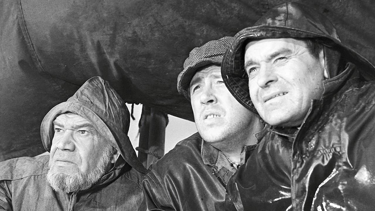 Men from the Fisherman's Village backdrop